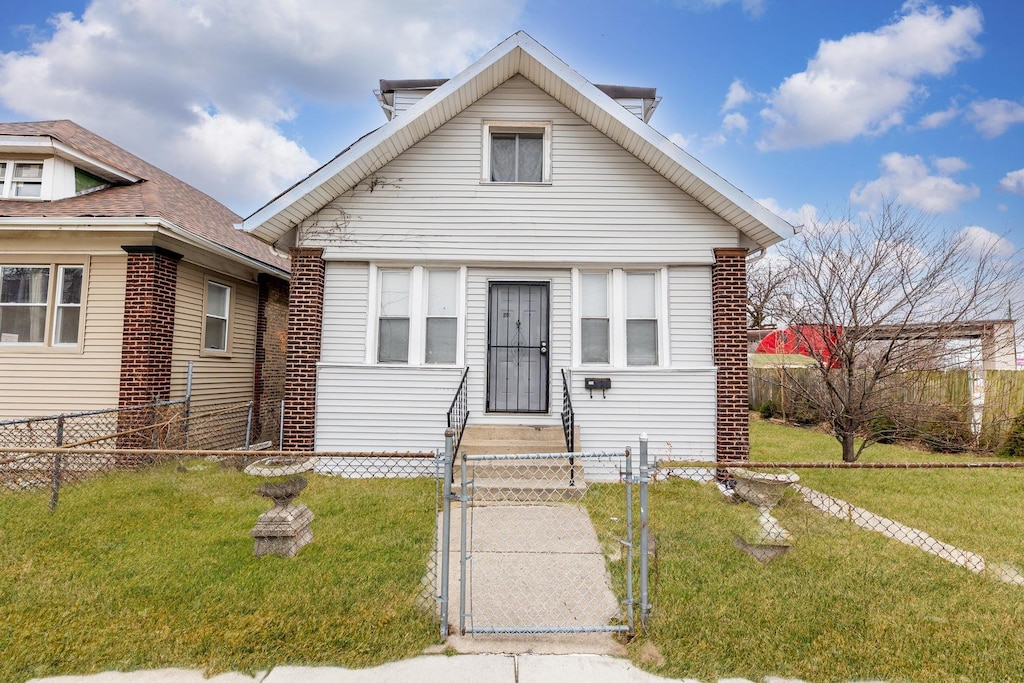 bungalow with a front lawn, a gate, and a fenced front yard