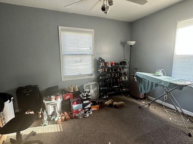 interior space featuring a ceiling fan and baseboards