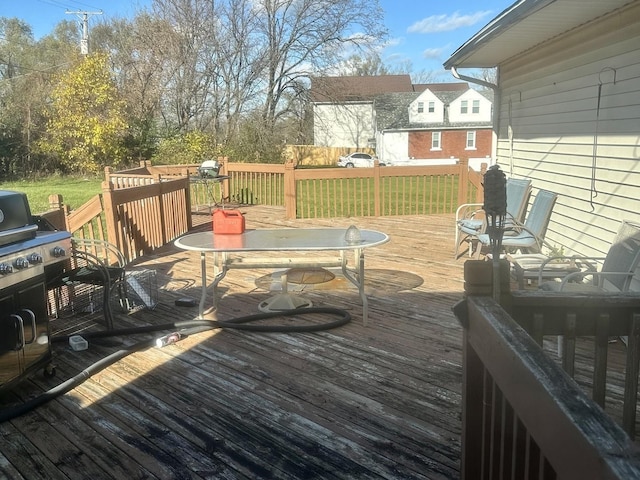 wooden deck featuring a yard