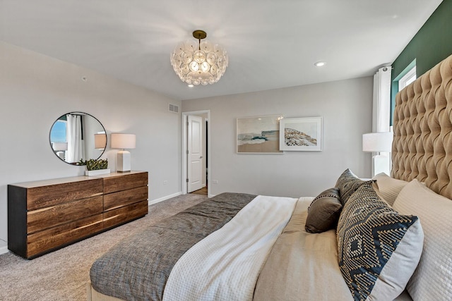 carpeted bedroom featuring visible vents and baseboards