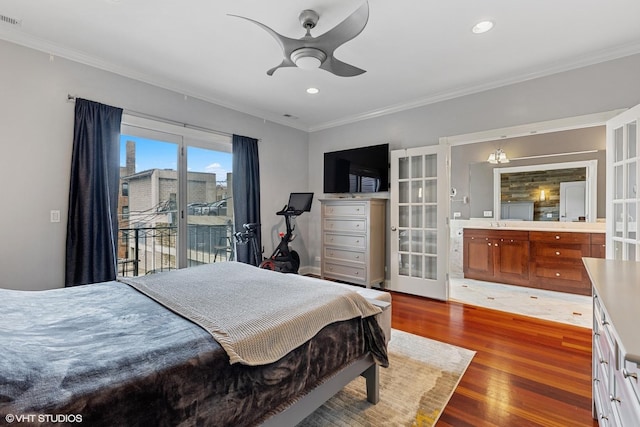 bedroom featuring access to outside, wood finished floors, visible vents, and ornamental molding