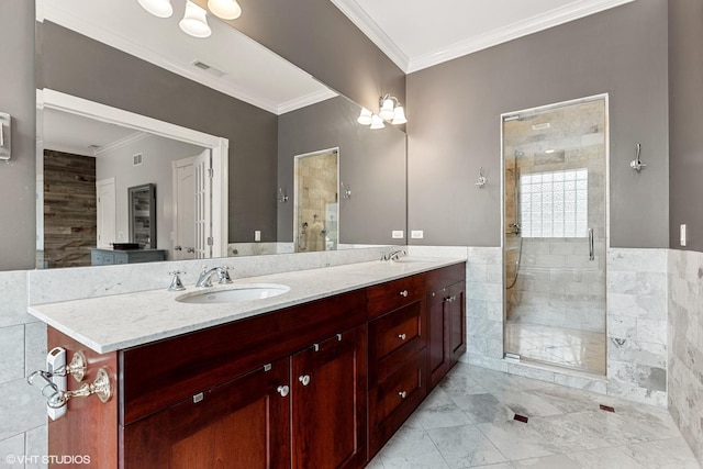 bathroom with a stall shower, ornamental molding, visible vents, and a sink