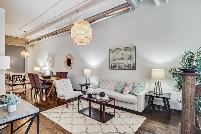 living room featuring wood finished floors and a towering ceiling