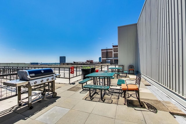 view of patio / terrace featuring a grill and a view of city