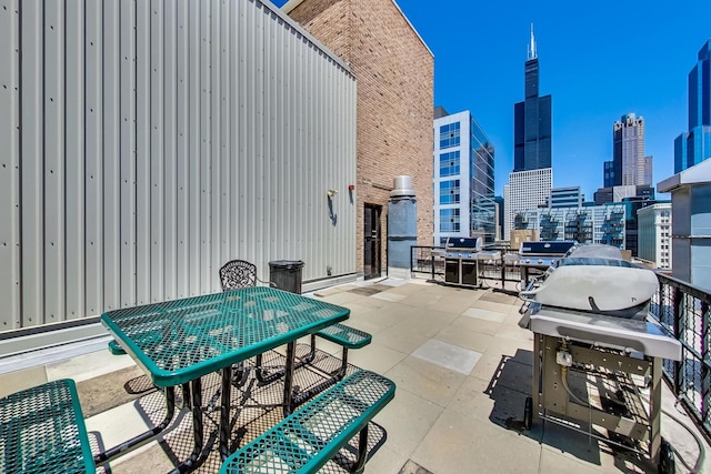 view of patio featuring a city view and outdoor dining space