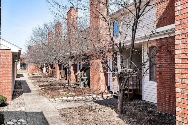 view of property exterior with brick siding