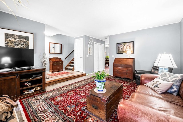 living room with visible vents and stairs