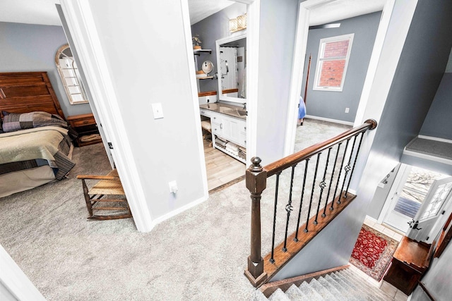 stairs with baseboards and carpet floors