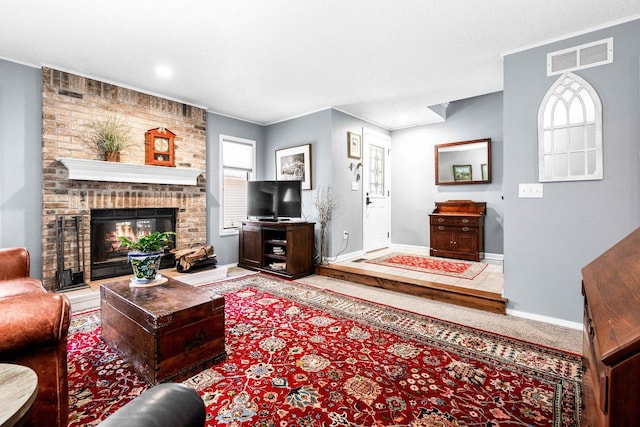 living room featuring a fireplace, visible vents, carpet floors, and baseboards