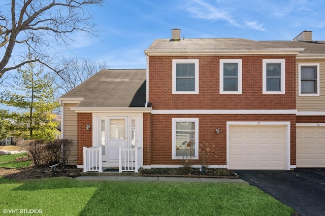 view of front of house with driveway, roof with shingles, a front yard, a garage, and a chimney
