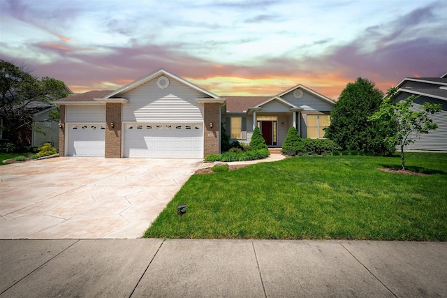 single story home featuring brick siding, a lawn, concrete driveway, and a garage