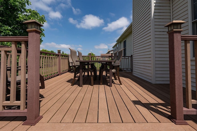 wooden terrace with outdoor dining area