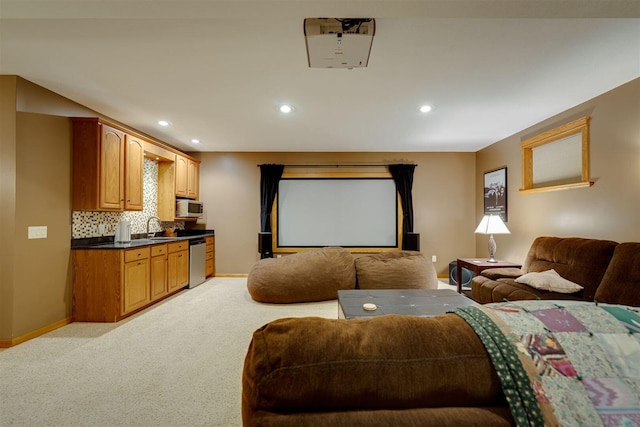 cinema featuring a sink, baseboards, light carpet, and recessed lighting