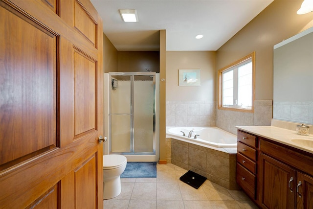 full bathroom with tile patterned floors, a shower stall, a bath, and toilet