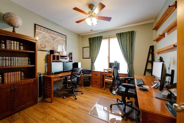 office space featuring light wood-type flooring and a ceiling fan