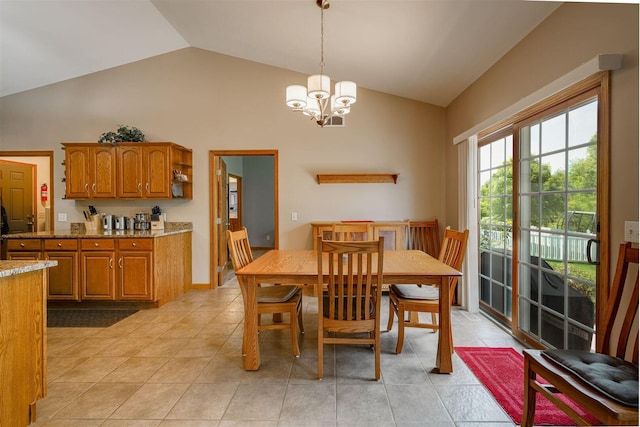 dining space with a chandelier, light tile patterned flooring, and vaulted ceiling