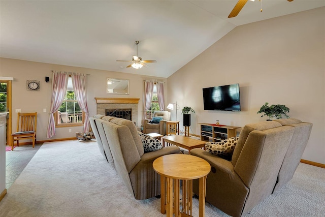 living area with light colored carpet, ceiling fan, and a fireplace