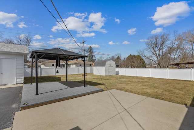 view of patio / terrace featuring a gazebo, a storage shed, a fenced backyard, and an outdoor structure