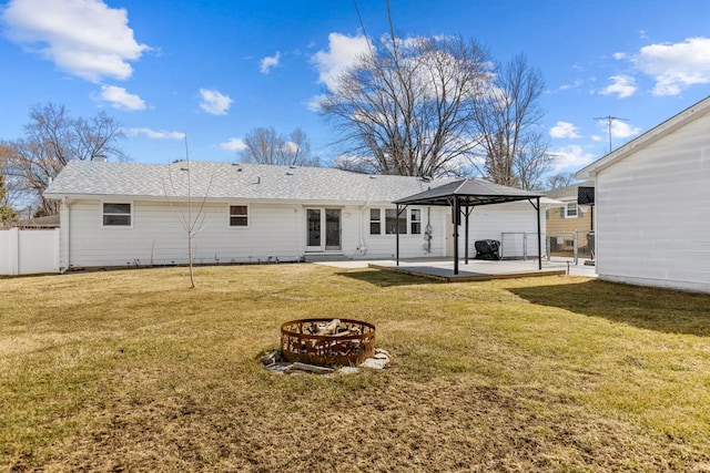 back of house with a lawn, fence, a gazebo, an outdoor fire pit, and a patio area