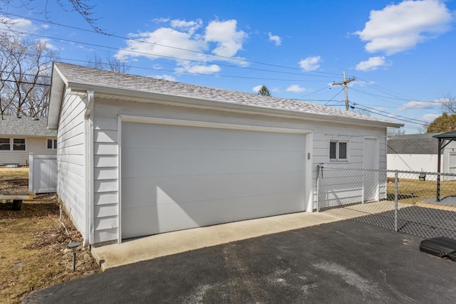 detached garage featuring fence