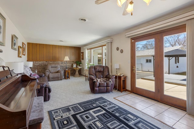 living room featuring plenty of natural light, french doors, visible vents, and light tile patterned flooring