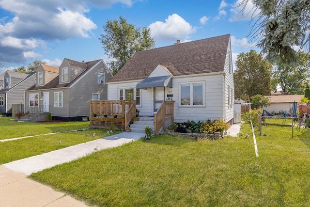 view of front of property with roof with shingles, a front yard, and fence