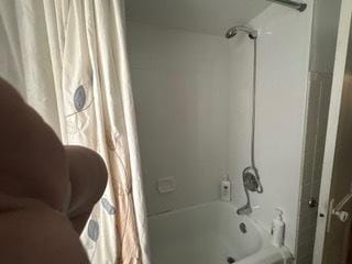 full bathroom with shower / bath combination with curtain