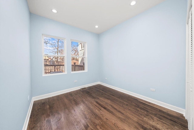 empty room featuring recessed lighting, visible vents, baseboards, and dark wood-style flooring