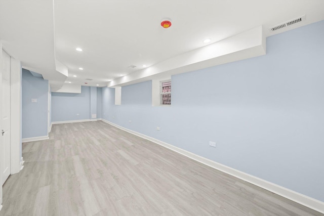 finished below grade area featuring recessed lighting, light wood-style floors, visible vents, and baseboards