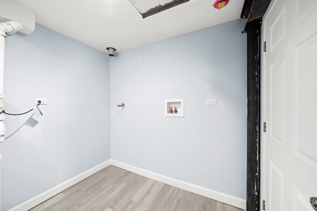 clothes washing area featuring washer hookup, laundry area, light wood-style floors, and baseboards