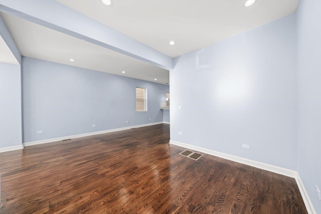 unfurnished room featuring dark wood-style floors, visible vents, recessed lighting, and baseboards