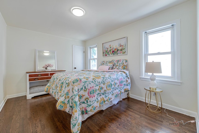 bedroom with wood finished floors and baseboards