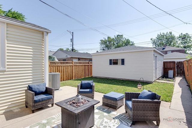 view of patio / terrace featuring an outdoor structure, central AC unit, a fenced backyard, and an outdoor living space with a fire pit