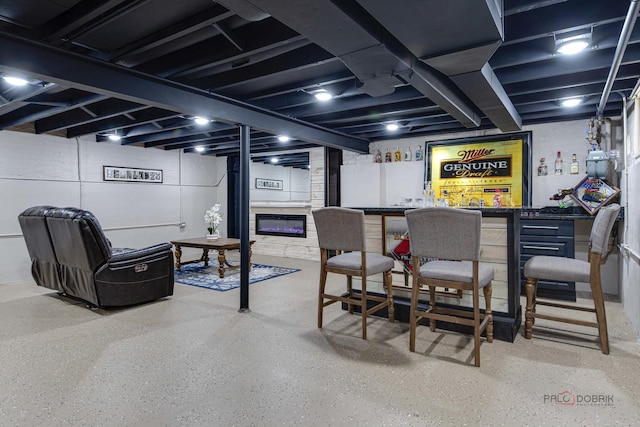 bar featuring a dry bar and speckled floor