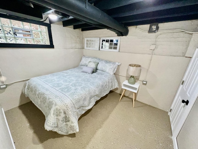 bedroom featuring finished concrete flooring