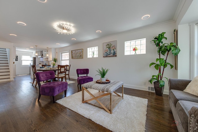 living room with stairway, dark wood-style floors, baseboards, visible vents, and crown molding