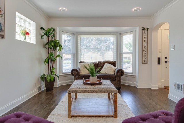 sitting room featuring visible vents, arched walkways, dark wood-style floors, and crown molding