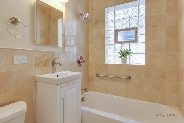 full bathroom featuring a wealth of natural light, vanity, toilet, and tile walls