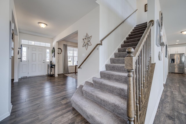 entrance foyer featuring recessed lighting, stairway, baseboards, and dark wood-type flooring