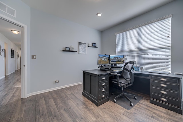 home office with visible vents, baseboards, and wood finished floors