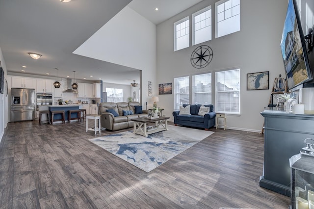 living room featuring dark wood finished floors, recessed lighting, and baseboards