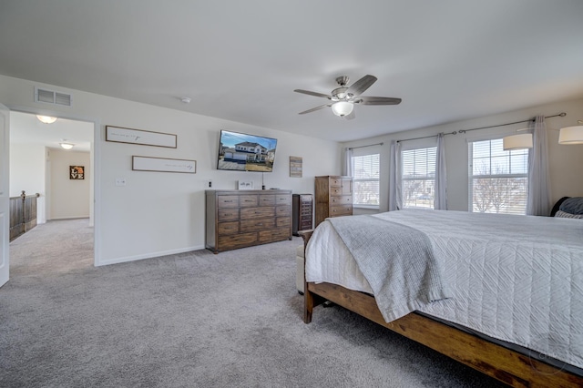 carpeted bedroom featuring visible vents, ceiling fan, and baseboards