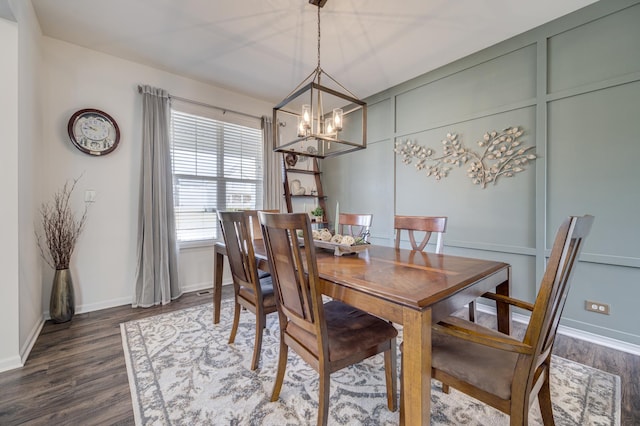 dining space with baseboards, a chandelier, and dark wood finished floors