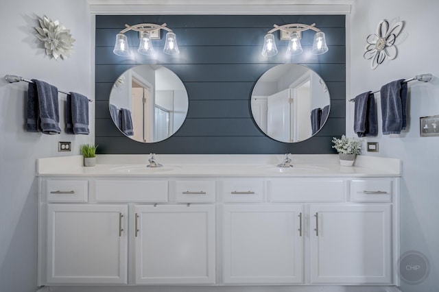 bathroom featuring a sink and double vanity