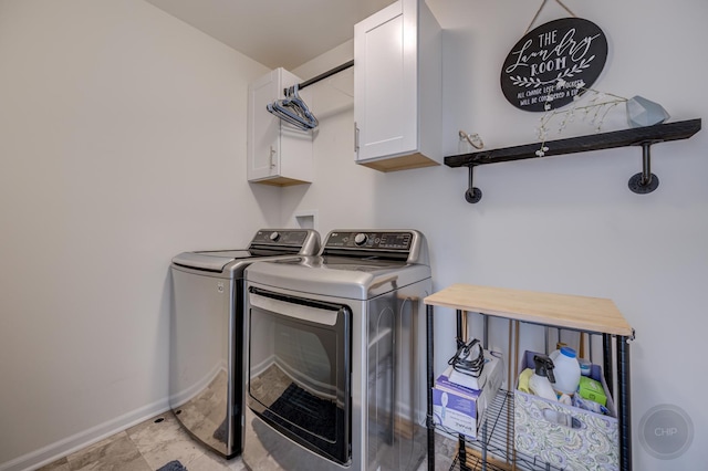 laundry room with cabinet space, washer and dryer, and baseboards