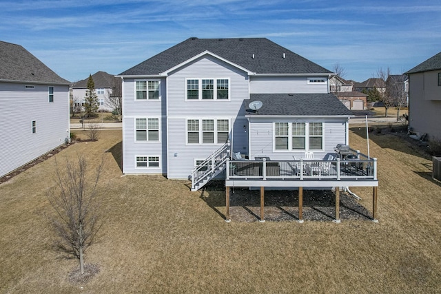 back of property featuring a yard, a deck, cooling unit, and roof with shingles