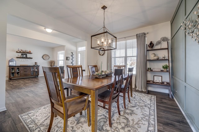 dining room featuring an inviting chandelier, baseboards, and dark wood-style flooring