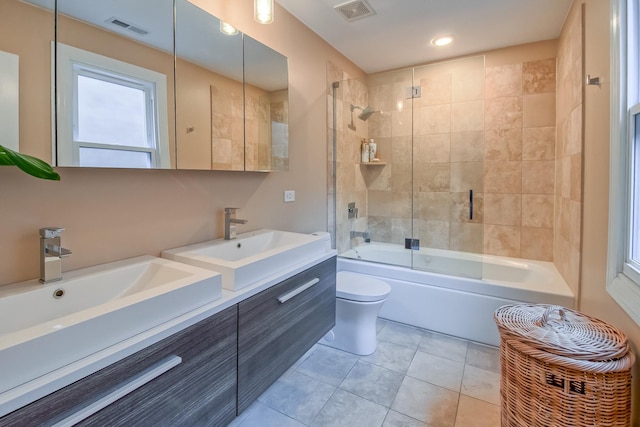 bathroom featuring tile patterned flooring, toilet, visible vents, and a sink