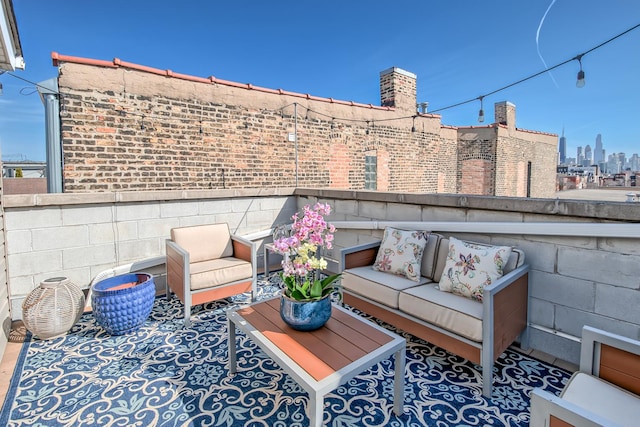 view of patio with a view of city, a balcony, and outdoor lounge area