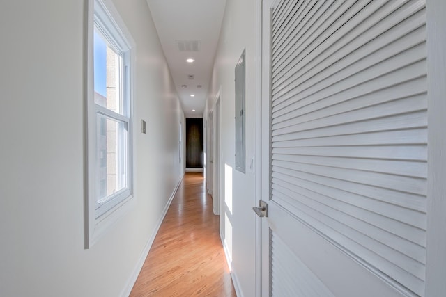 corridor with recessed lighting, visible vents, baseboards, and light wood finished floors